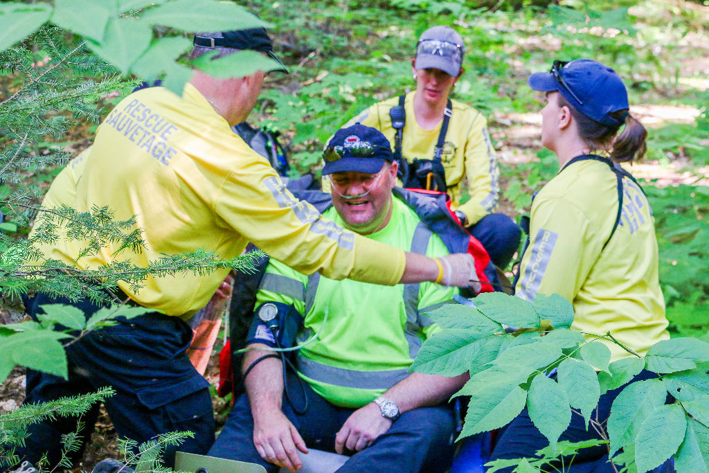 Search and rescue team assessing the condition of a subject during a wilderness first responder course run by boreal river rescue