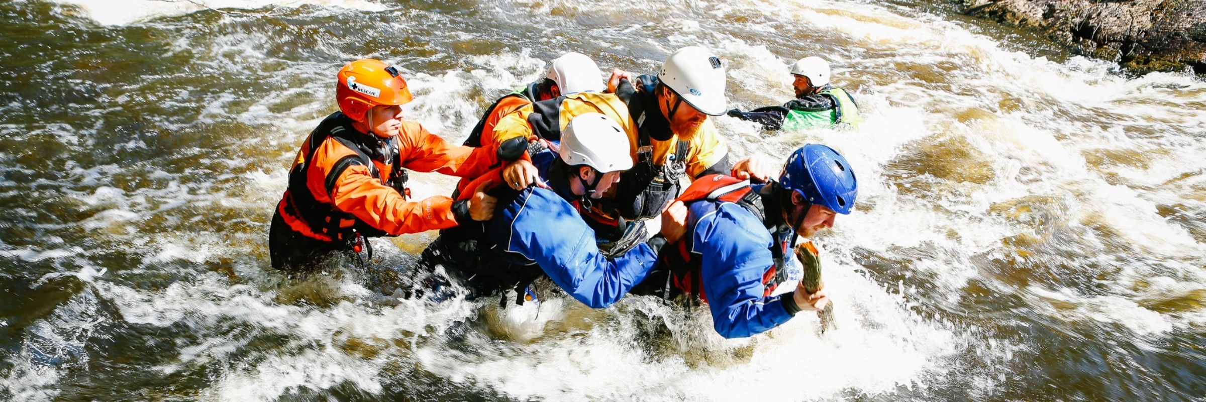 People participating in a water rescue exercise in a river