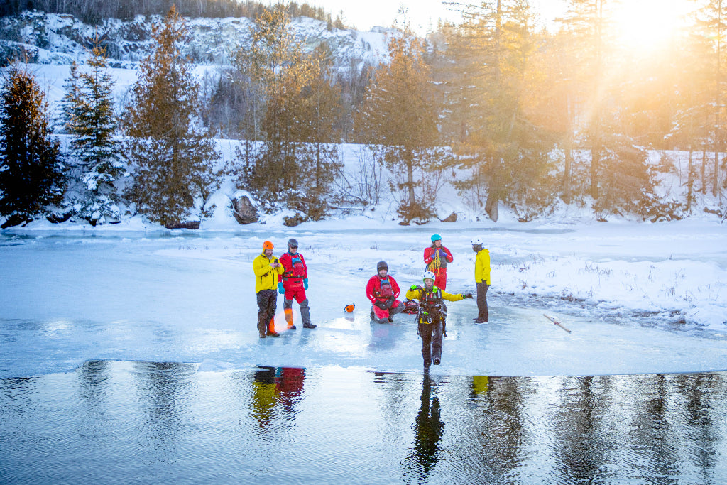 Ice rescue student stepping over the edge of ice into water